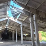 An agricultural warehouse stands damaged by Russian shelling