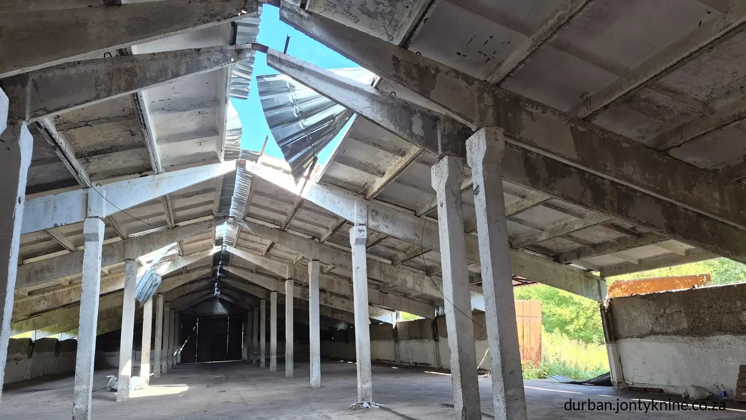 An agricultural warehouse stands damaged by Russian shelling