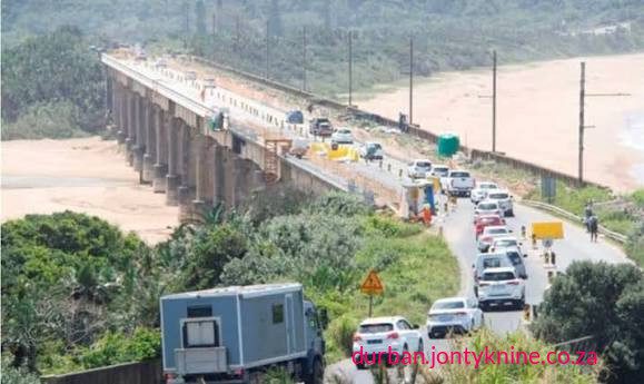 The R190 million emergency rehabilitation of the uMzimkhulu (Mzimkhulu) River Bridge on the R102 near Port Shepstone has stretched from a planned six-month job into a multi-year saga marked by structural complexity, repeated stoppages over non-payment, cash-flow problems at the KZN Department of Transport, weather and technical setbacks, and significant local economic disruption The R190 million emergency rehabilitation of the uMzimkhulu (Mzimkhulu) River Bridge on the R102 near Port Shepstone has stretched from a planned six-month job into a multi-year saga marked by structural complexity, repeated stoppages over non-payment, cash-flow problems at the KZN Department of Transport, weather and technical setbacks, and significant local economic disruption